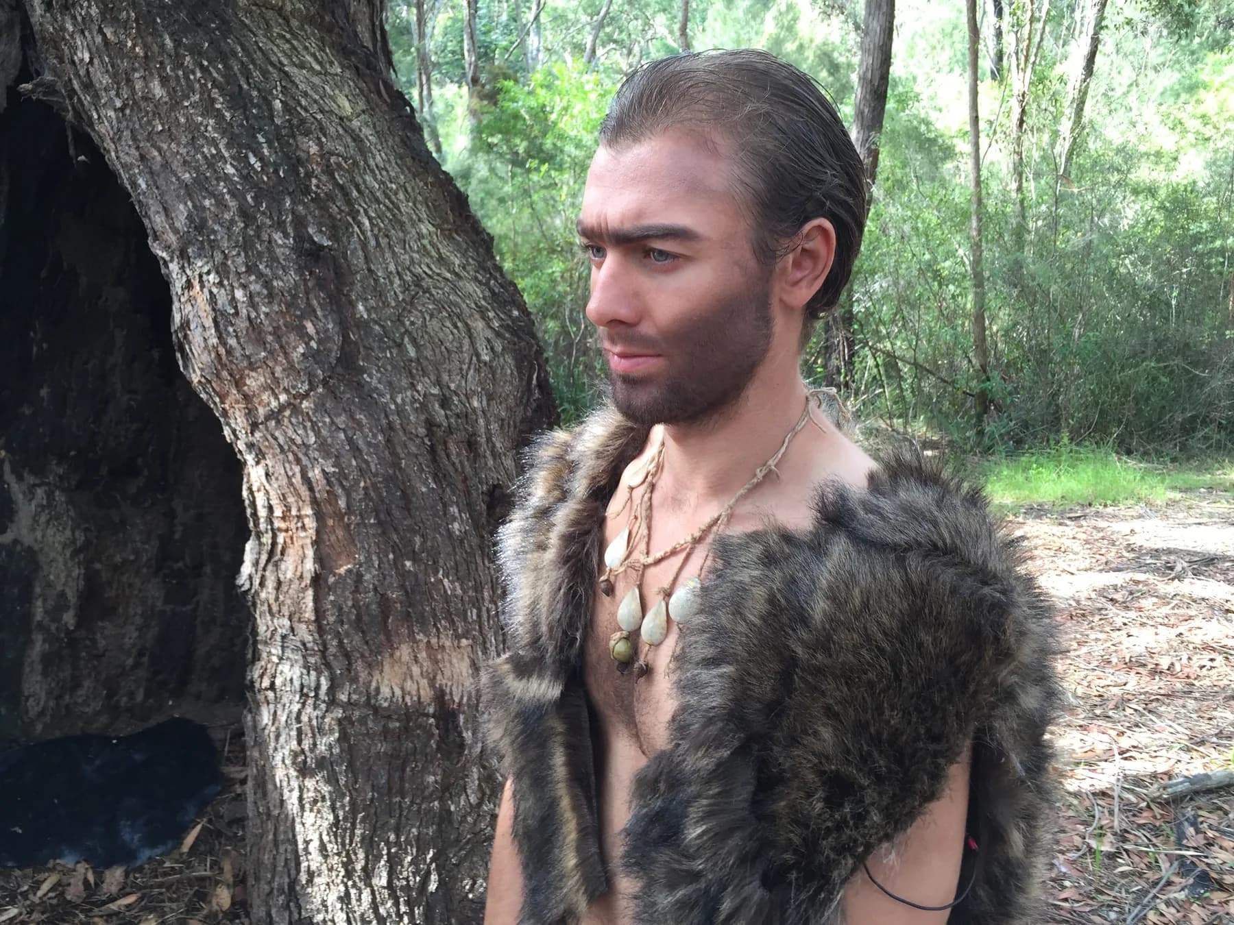 A cast member in prehistoric costume on location