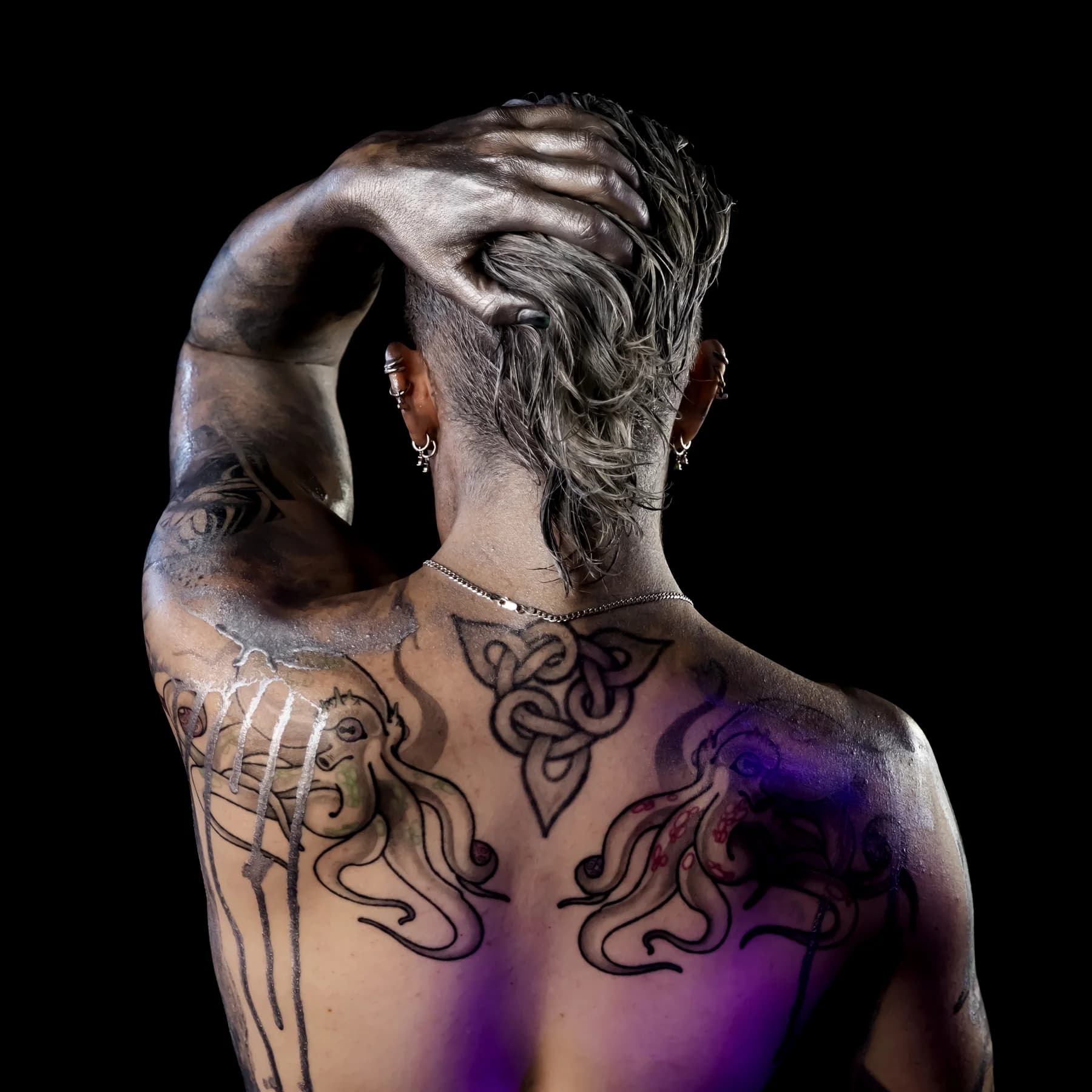 Mercury covered in silver body paint against black