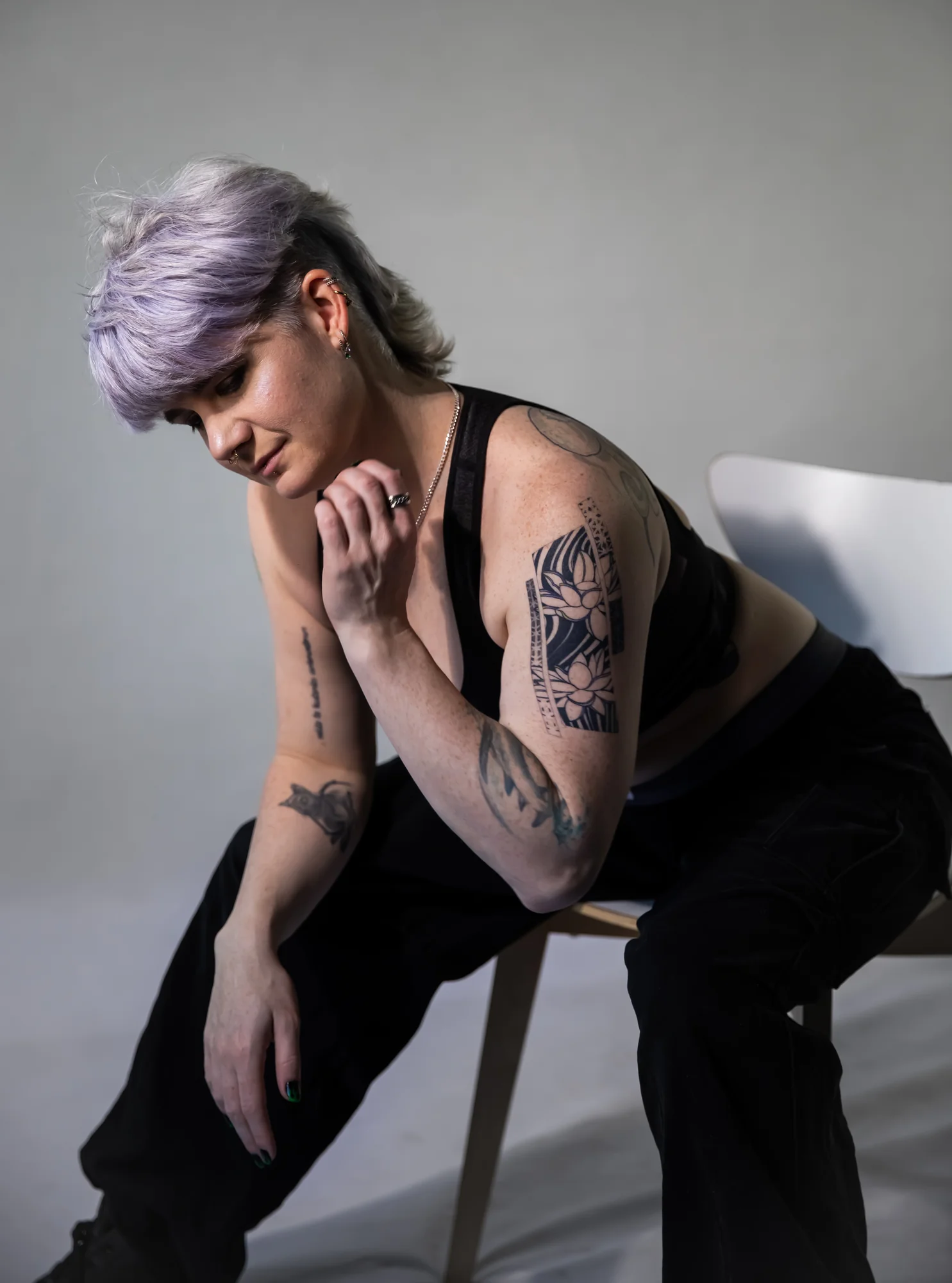 Mercury seated against a light background