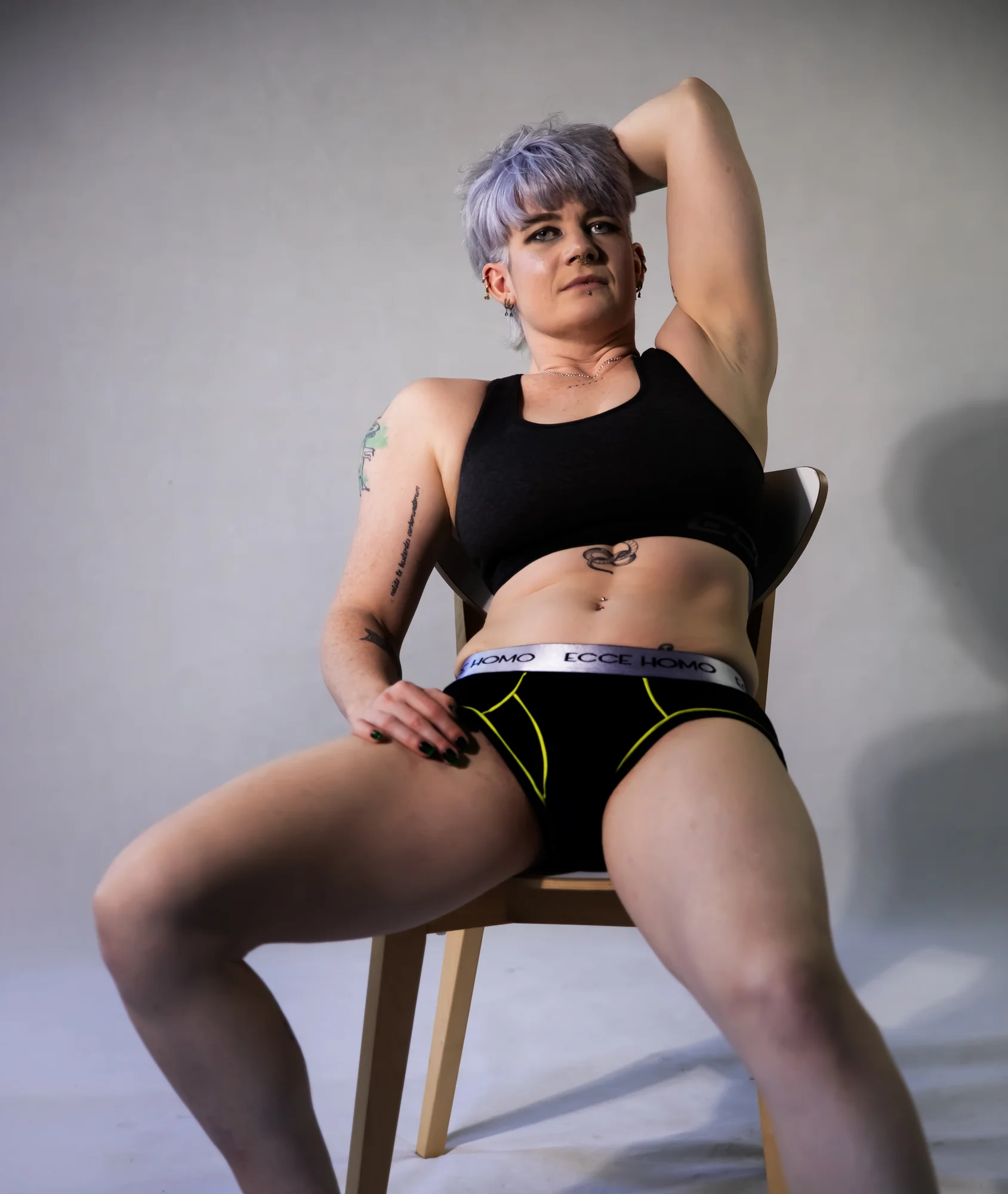 Mercury posing on a chair against a light background