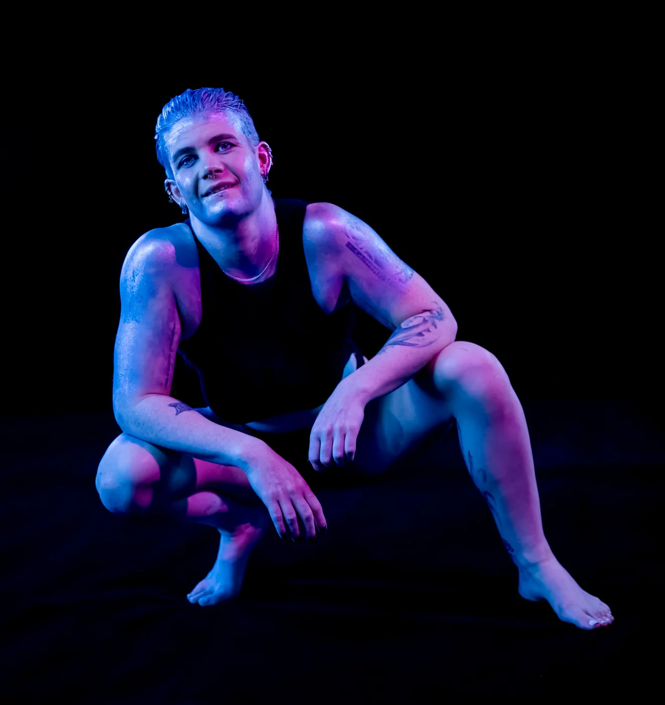 Mercury seated under purple and blue light