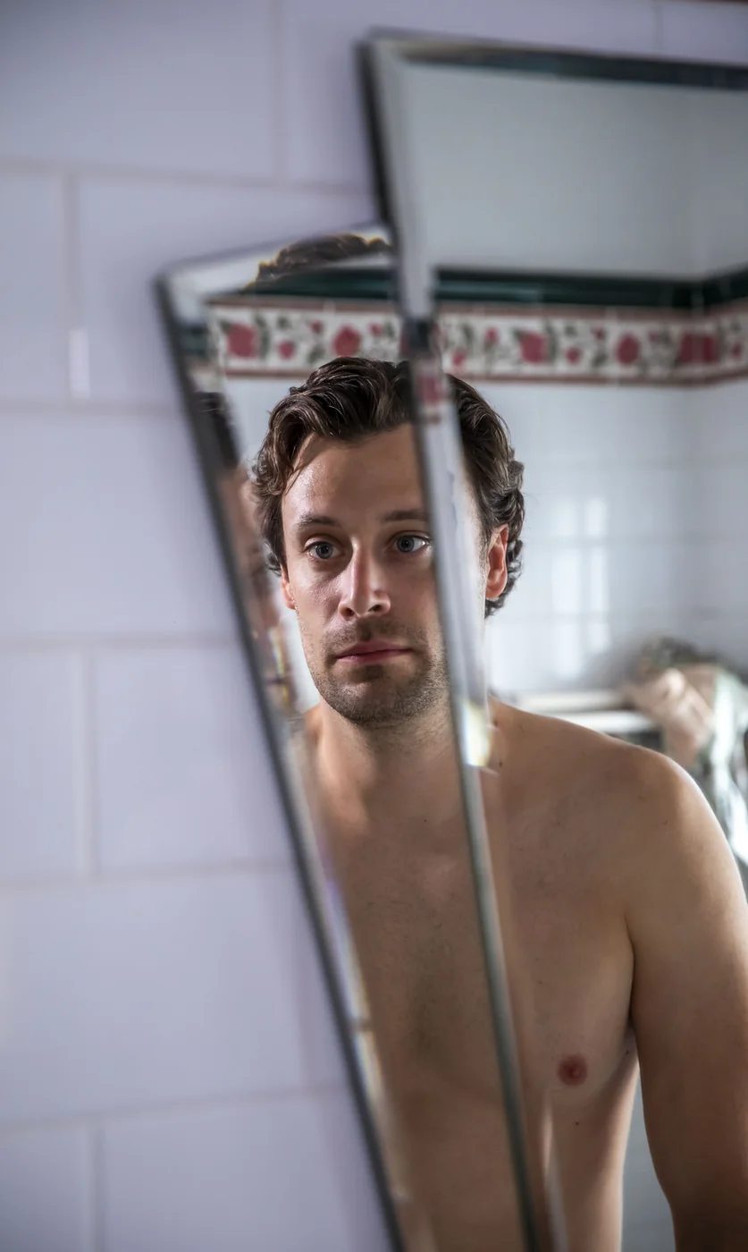 Portrait of Chris reflected in a bathroom mirror