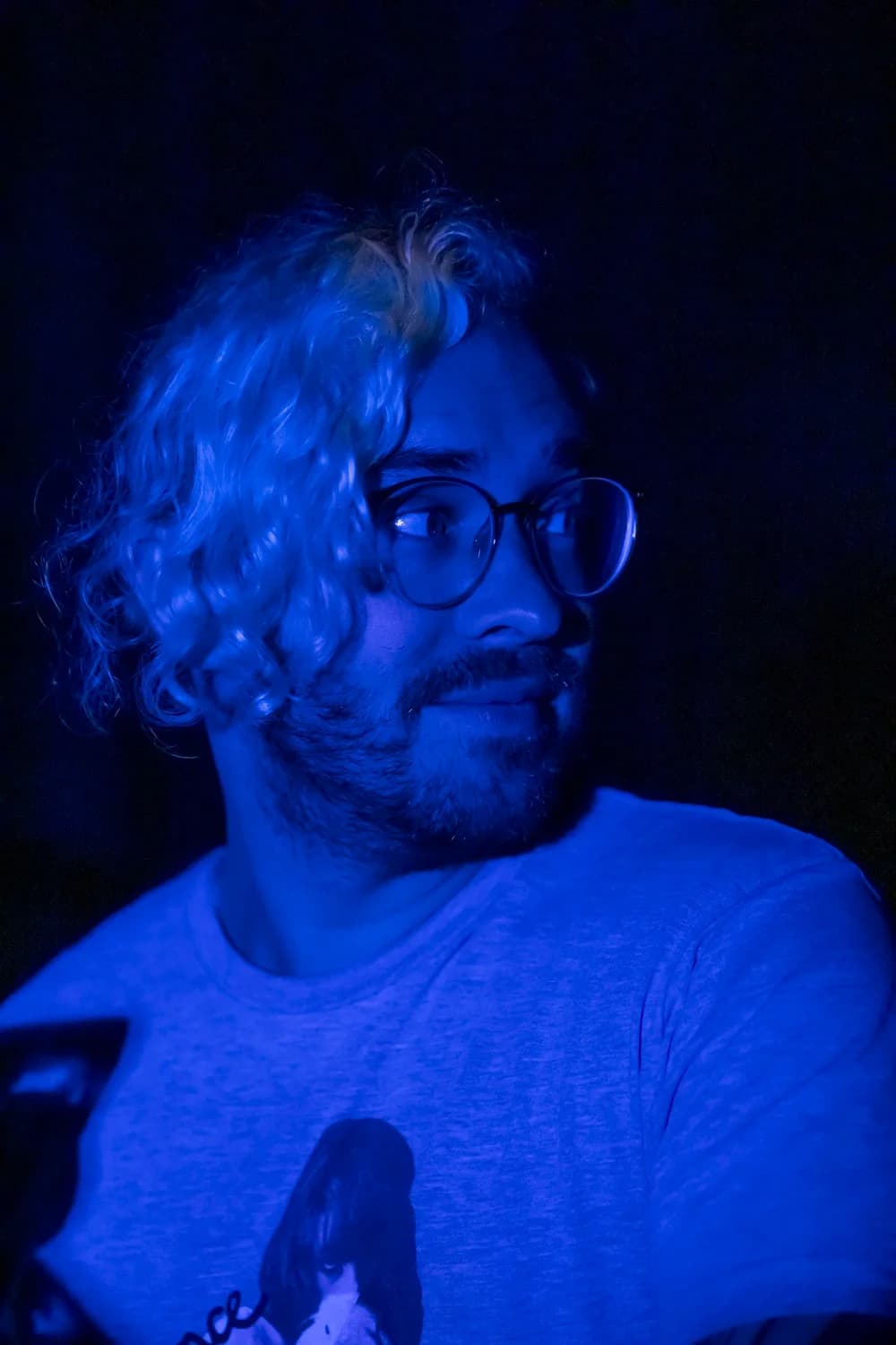 Landon Maxwell lit by blue projection light on set