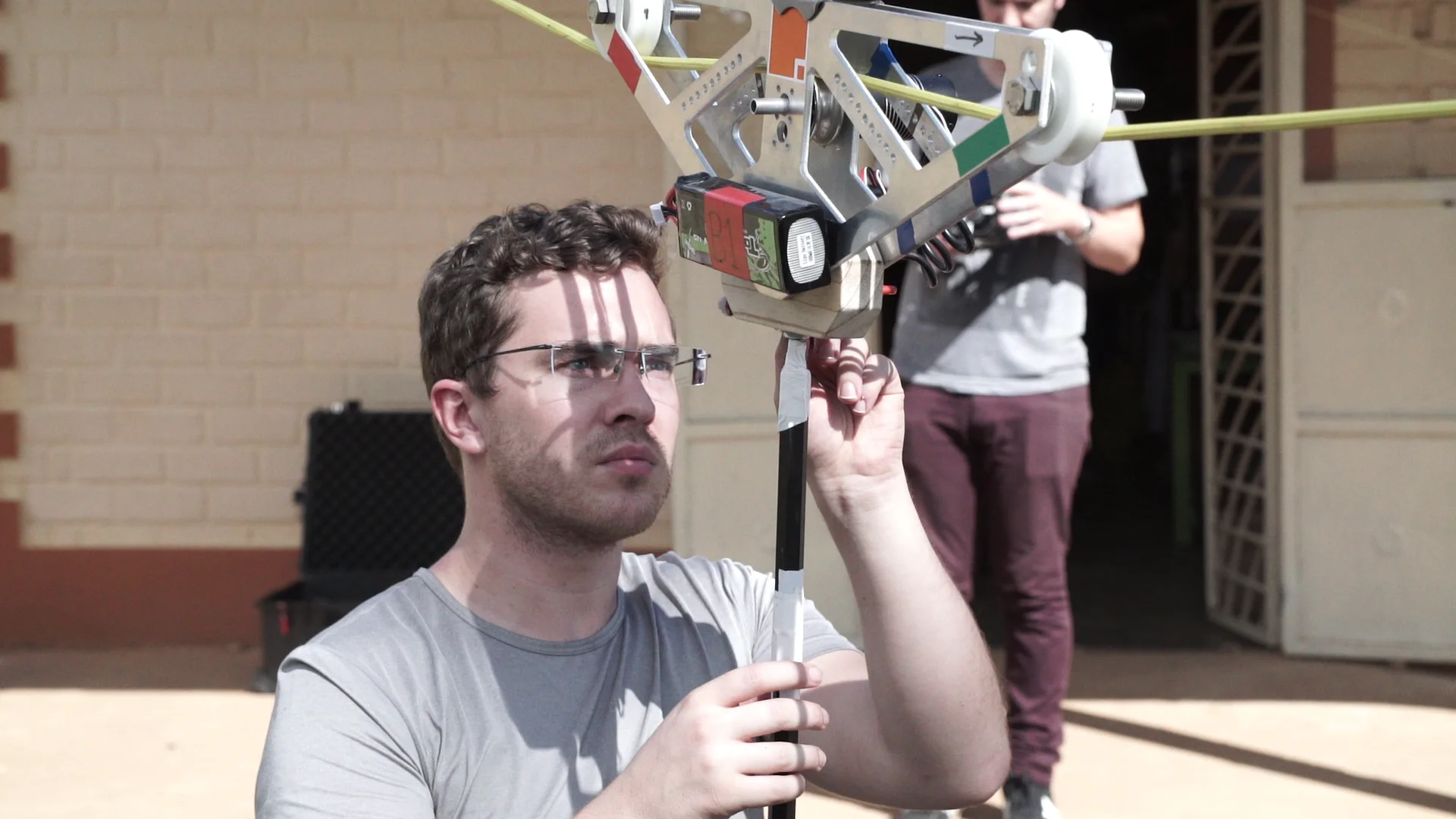 Landon Maxwell preparing the 360-degree camera system in Uganda