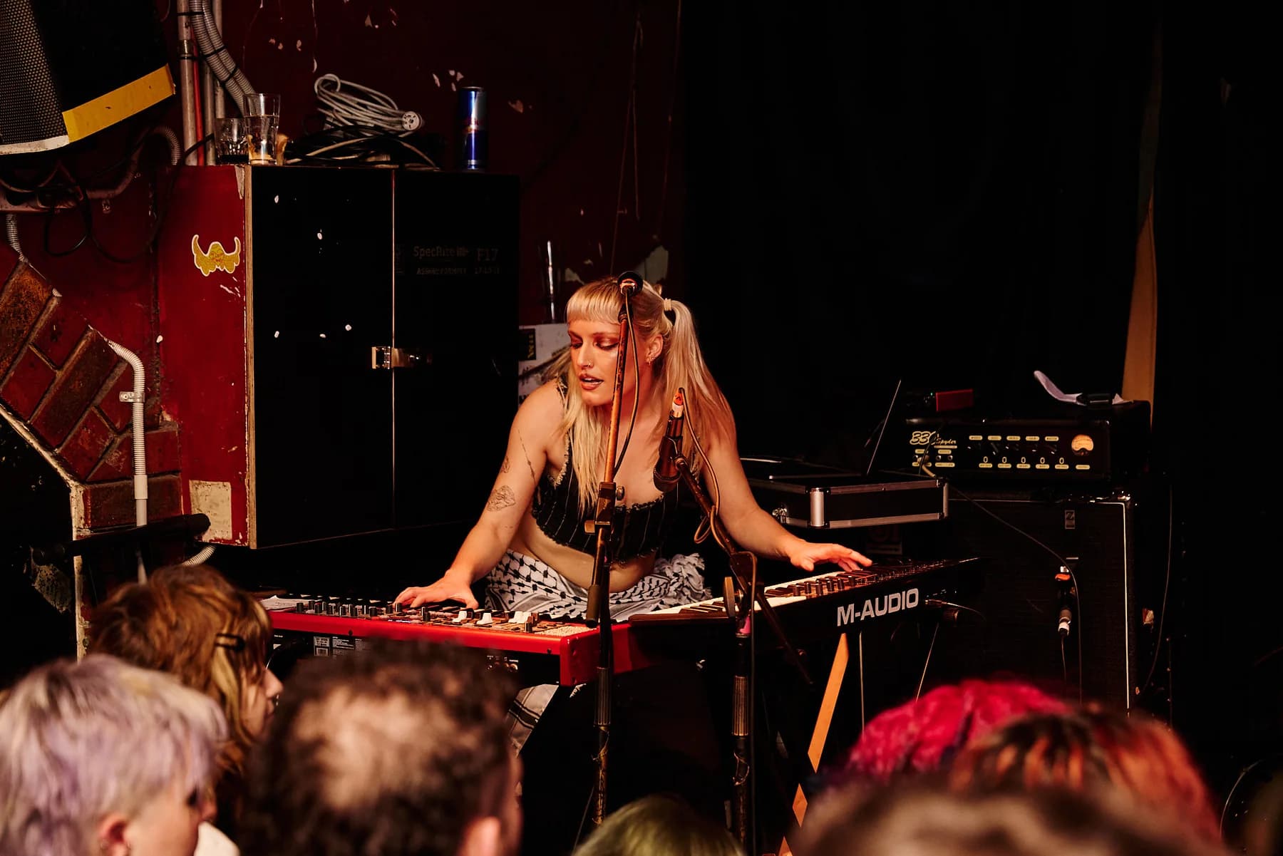 Performer on stage under red light