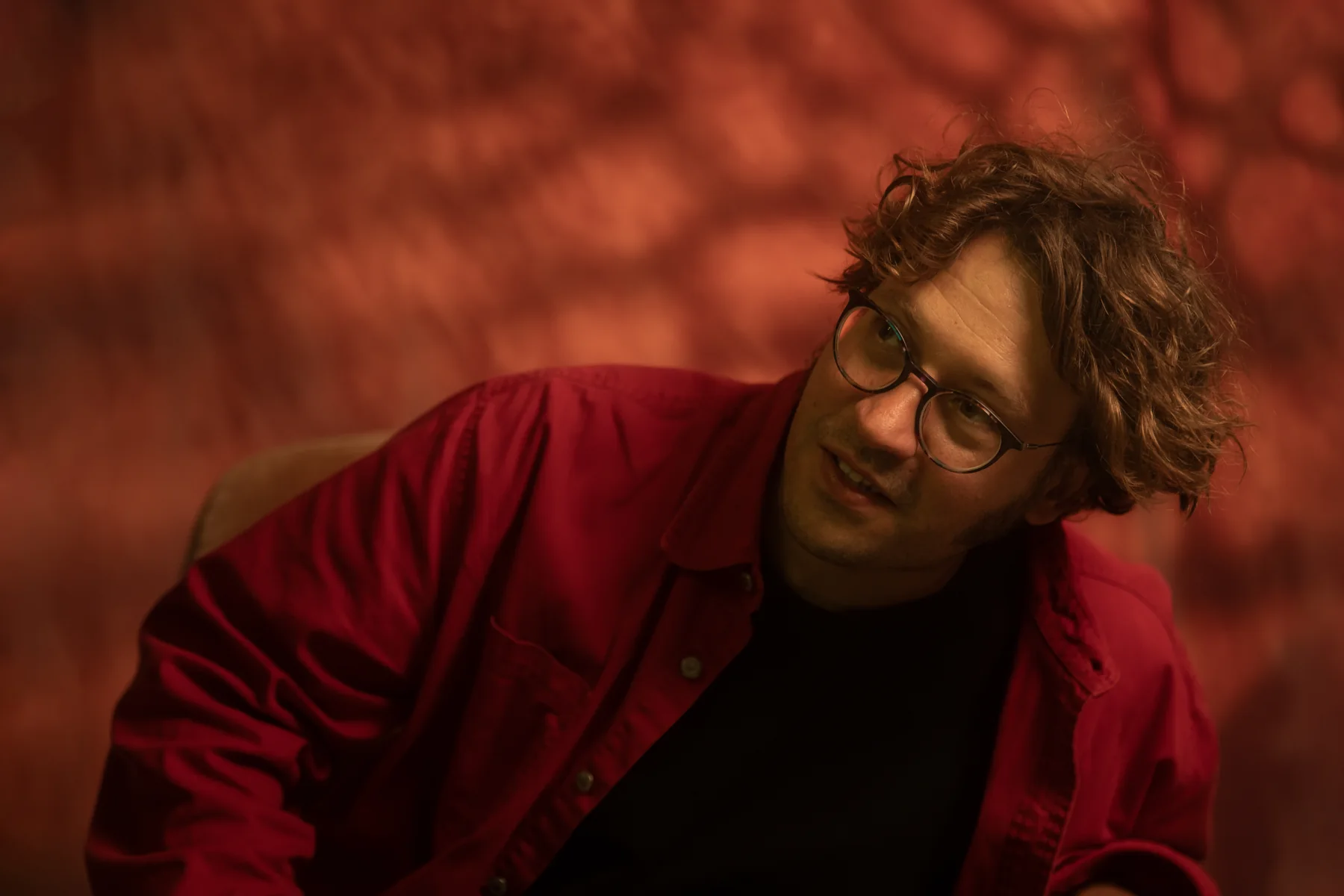 Harvey Pink in a warm red portrait setup