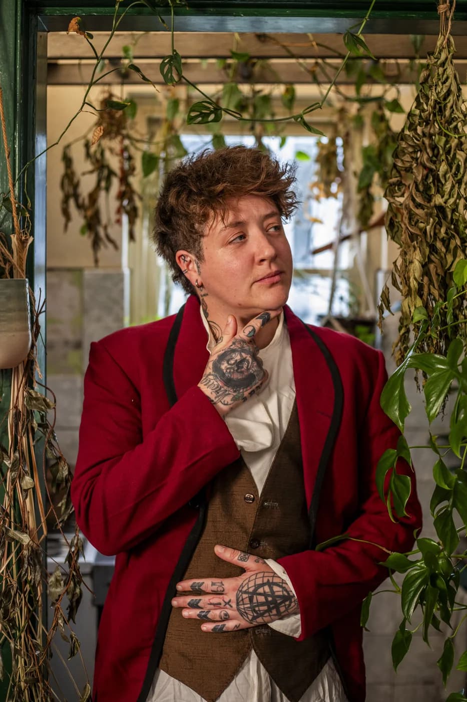 Ollie performing in a red jacket in the kitchen