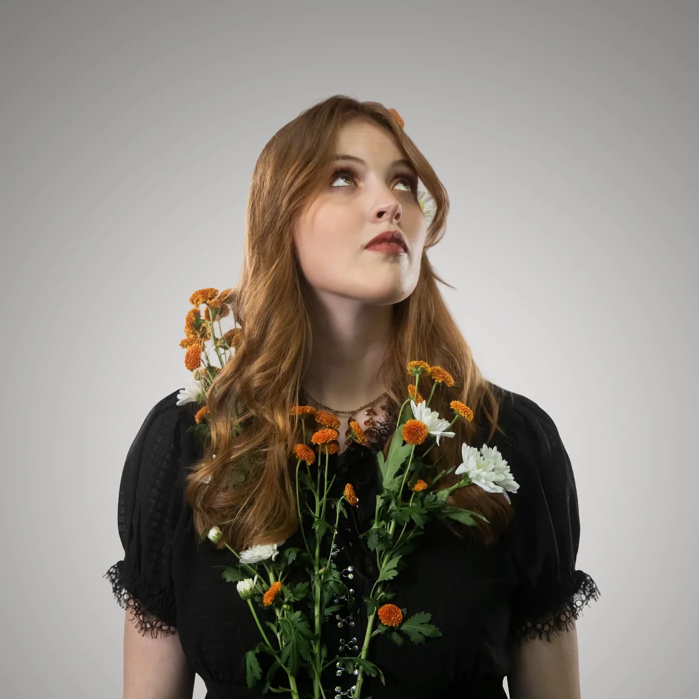 Sadie Mustoe wearing flowers against a neutral backdrop